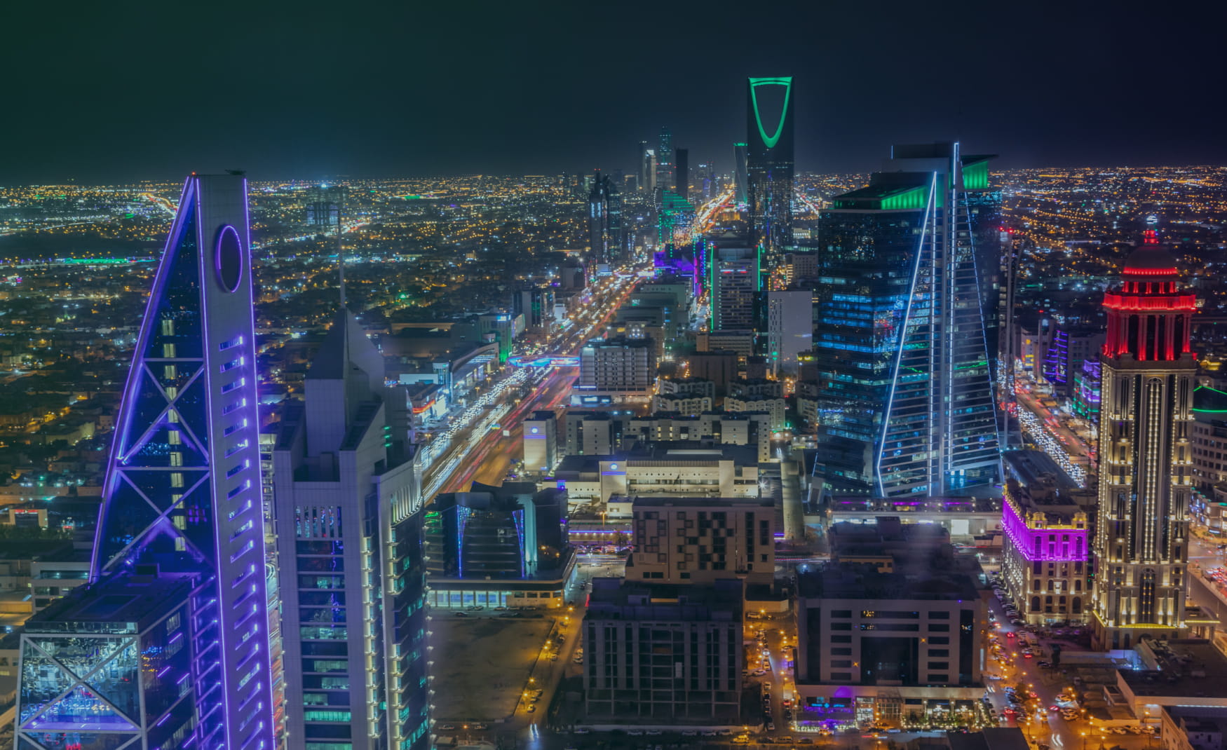 City skyline at dusk with illuminated towers